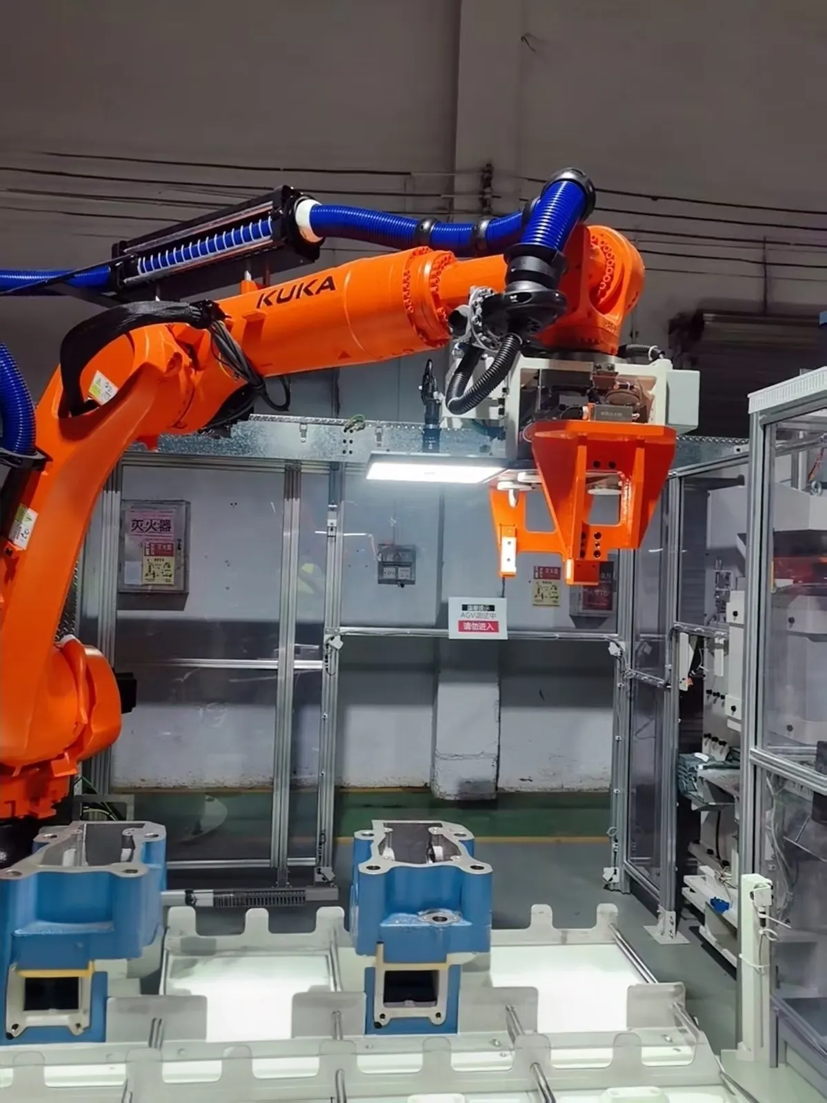 KUKA robot vision loading station integrated with engine assembly automation